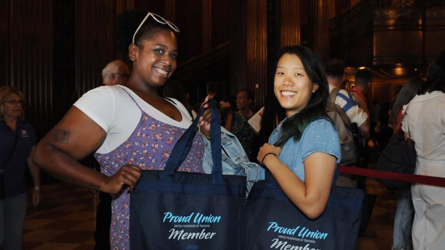 Two women pose for a photo at a new teacher event 