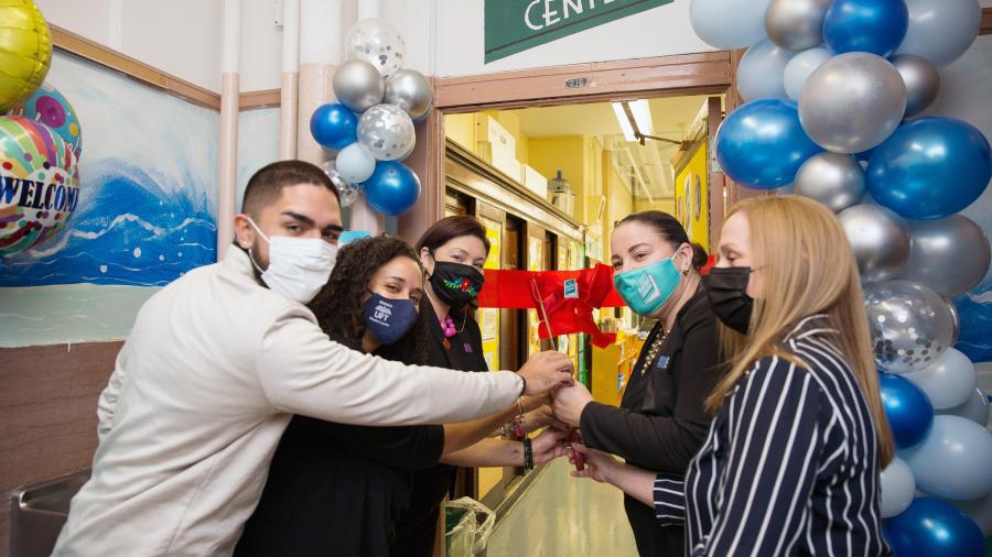 Doing the honors at the Longwood Academy of Discovery in the Bronx are (from left) state Assemblyman Kenny Burgos, Chapter Leader Stephanie Sangosse, Principal Victoria Najera, Teacher Center site coach Veronica Vadi and UFT District 8 Representative Karen Aldorando.