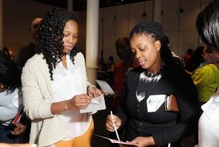 Providers Wiles (left) and Keilyn Arauz of Brooklyn write with quill pens made f
