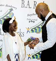 Lamar Smith slips a corsage on the wrist of his stepdaughter, Kaia.