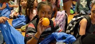 A student reveals the hidden treasures inside the blue plastic bags.