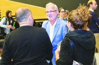 Rollins greets participants.