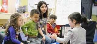 Teacher Sandy Fajgier watches as her pre-K students use VHS tapes — circa 1980 —