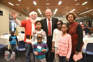 Children pose with Santa (aka the UFT’s secretary, Emil Pietromonaco), UFT Presi
