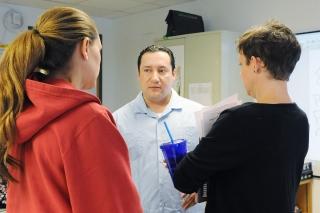 Chapter Leader Arturo Molina talks with colleagues at a recent chapter meeting.