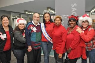 Santa’s helpers for the day include (from third from left) Bob Astrowsky, an ass