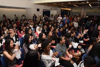 Students applaud during the ceremony.
