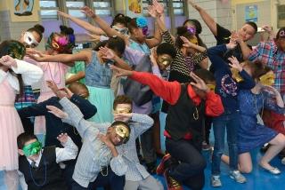 Masked revelers crowd the dance floor.