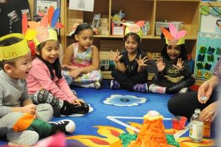 Diverse early school aged children sitting in a circle learning a lesson