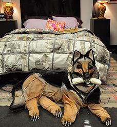 The paper-mache German shepherd at the foot of the bed actually growls at anyone