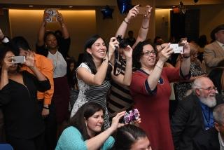 Attendees strain to get photos of the honorees.