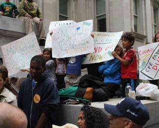 Public school students gather on the steps of Department of Education headquarte