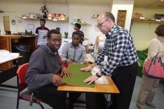 Chapter Leader Albert Justiniano (right) and two students show the materials the