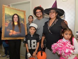 PS 6 teacher Sarito Flores-Aponte (second from right) is all dressed up and read