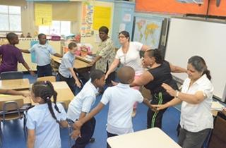 Teachers (from left) Ernestine Seymour, Lydia Guzman, Yehudith Holder and Mariamma Varughese help shake out any lazy bones during the school day at PS 631 in Brooklyn. 