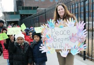Teacher Maria Sanyshyn and her kindergartners show off their signs.