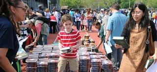 Kids browse through the stacks of books in the schoolyard at Abraham Lincoln HS 