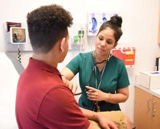 Nurse Marisol Leon listens to a student’s heart at the new clinic.