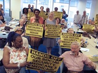 Retirees hlding signs, "Hands off our social security"
