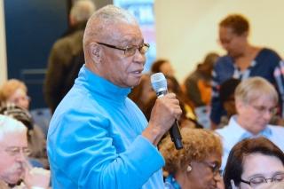 Retiree Stanley Albritten asks Ost a question.