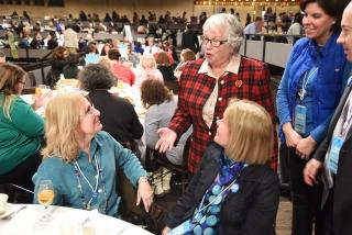 New York State Sen. Toby Stavisky (speaking) catches up with educators Sharon St