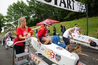 Jennifer Aiello, a teacher at PS 22 on Staten Island, helps a 3rd-grader get int