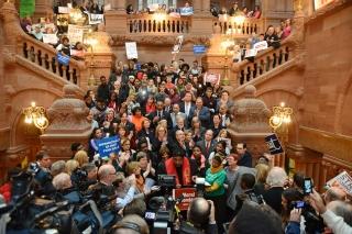 The crowd spreads up the indoor staircase at the Capitol building in Albany