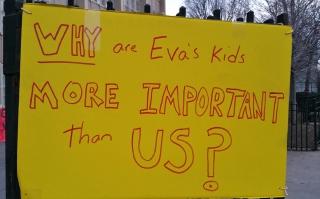 One of the signs posted on the fence outside the school on the day of the hearin