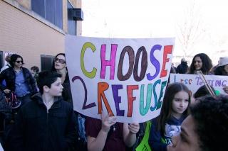 Opting out was on the minds — and on the signs — of some parents and students fr