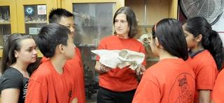 Teacher Darlene Colmone talks about the anatomical features of a large animal skull during a Science Olympiad meeting after school at JHS 194, Queens.