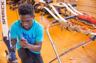 Getting ready to draw back his bow.