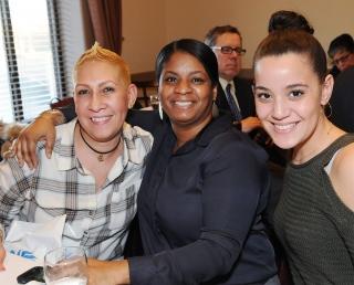 Honoree Esther Maldonado-Smith (left) is congratulated by PS 373 colleagues Pame