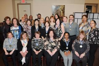 Honorees, with UFT District 75 Representative Analia Gerard (standing, left), ge