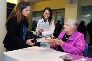 Ravitch signs copies of her book for Manhattan teachers