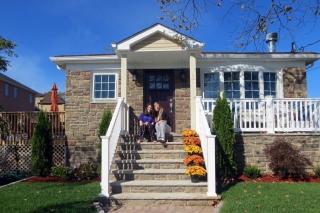 Raimondi and her daughter in front of their renovated home in Midland Beach.