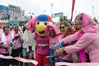 Members help cut the ribbon to kick off the Coney Island walk.