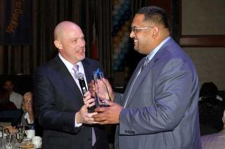 Chapter Leader David Doorga (right) accepts a Schools in Action Award on behalf 
