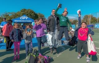 Members of the Marke family jump for joy with their books.