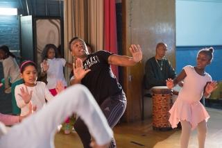 Alvin Ailey dancer Adesina Sampson directs the 4th-graders.