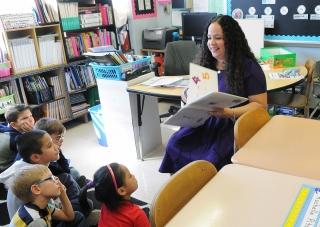 A class of 2nd- and 3rd-graders listens to Liebowitz read “One,” by Kathryn Otos