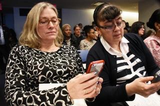 Diana Guiterman (left) and Carmen Rodriguez of PS 182 in Manhattan use their cel