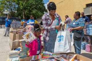 Naja Watts from Far Rockaway helps her daughter Mia pick out books.