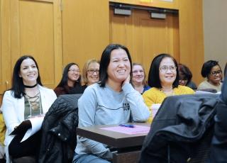 A speaker’s comment sparks smiles among the nurses.