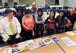 Participants look over artifacts during the theater arts workshop.