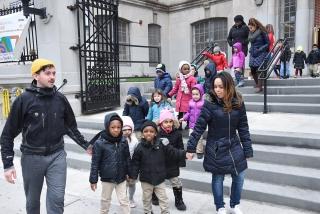 Liam O'Malley and April Rosario lead pre-K students to the library. 
