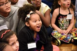 A little girl can’t believe her eyes as the magician makes things disappear.