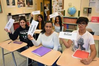 Students display their designated country on placards.