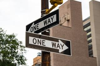 One-way signs pointing in opposite directions