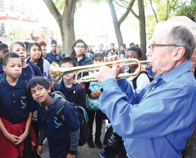 Docent Ed Polcer, a cornet player who has performed at the White House and the r