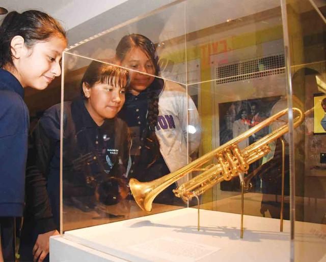 Students check out one of the trumpets owned by the jazz great, minutes after th